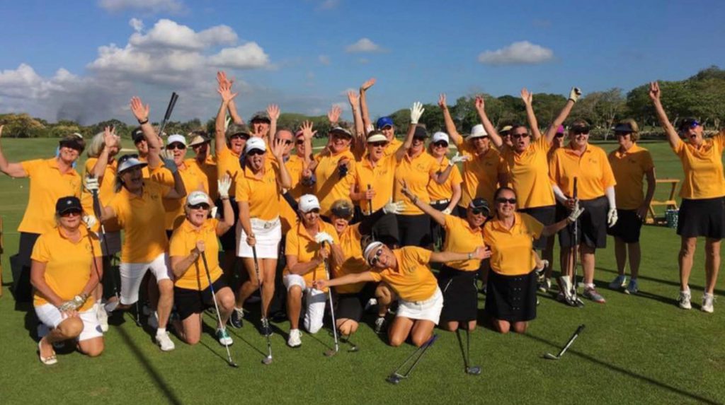 group of women golfers in yellow shirts